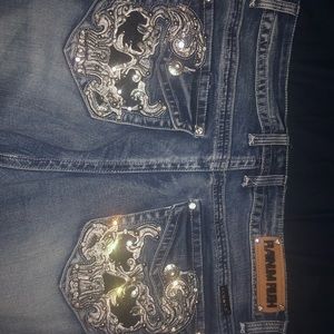 Boot cut jeans with sparking skeleton back pockets